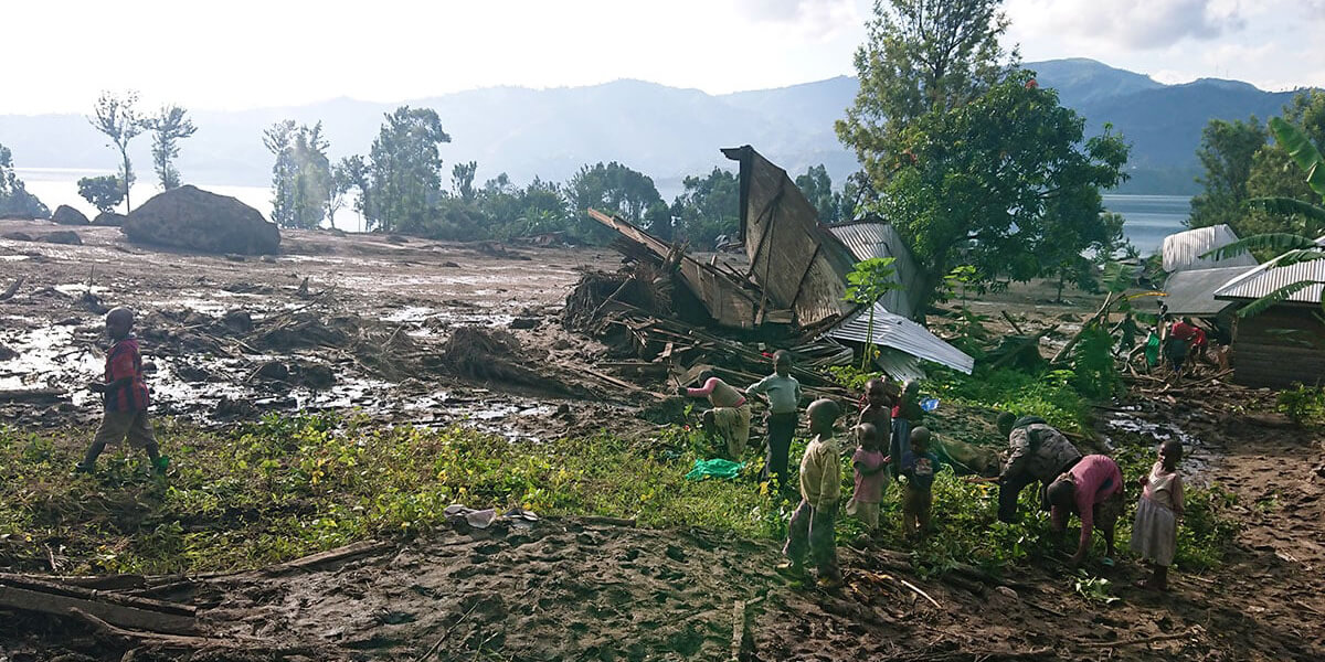 Children walk among the destruction caused by massive flooding in the Bushushu village in Kalehe, Congo. More than 175 people, including 15 United Methodists, died after torrential rains overflowed the Chibira River in South Kivu. (Photo: Philippe Kituka Lolonga, UM News.)