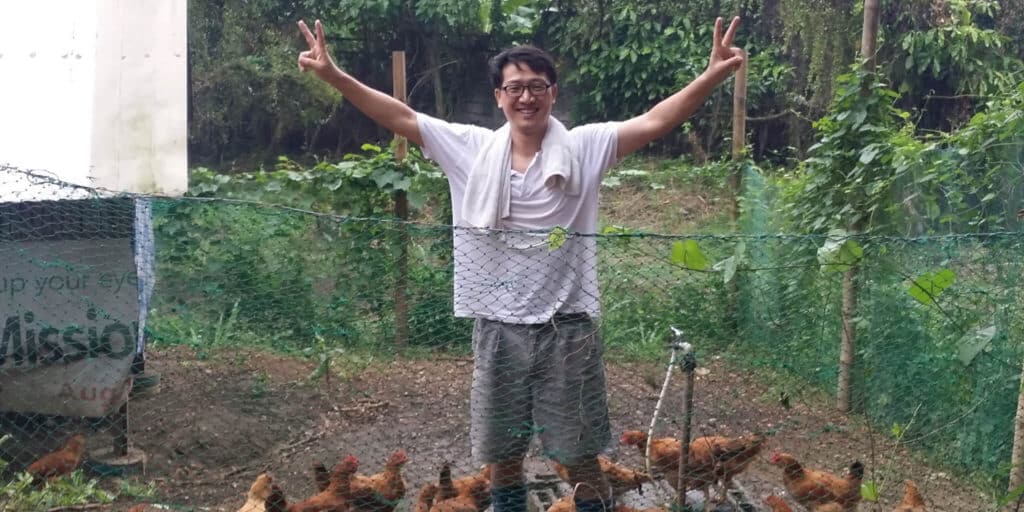 The Rev. Jay Choi in the chicken coop at Goshen Organic Farm in the Philippines, where the grass-fed chickens they raised also raised funds for the Land Justice Center at Union Theological Seminary, where he worked. (Photo: Rev. Dr. Alan Cabas)