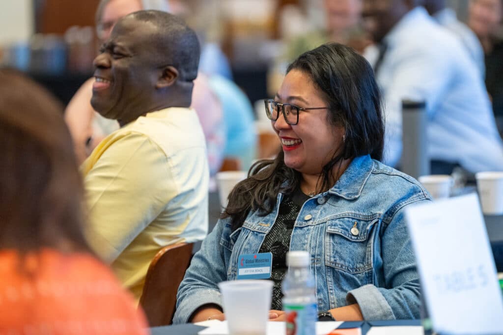 Missionaries Joy Eva Bohol and Jean Claude Masuka Maleka laugh during the consultation’s closing session. (Photo: Adam Bowers)