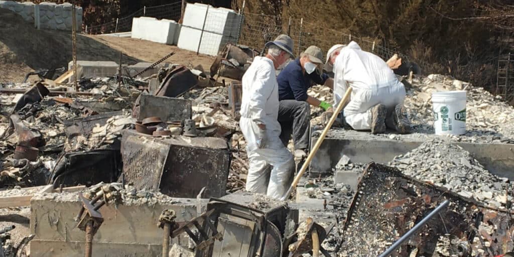 A California-Nevada Conference volunteer teams sifts through the ashes of a survivor’s former home at the survivor's request. (Photo: (Photo: Courtesy of the California-Nevada Conference CDRC)