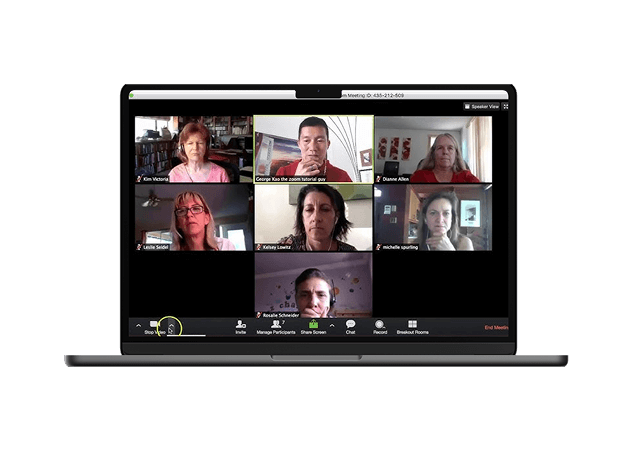 a laptop showing a Zoom call with several people